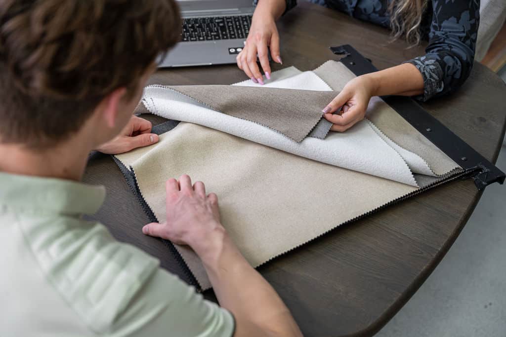 Advisor and client reviewing fabric samples in a showroom